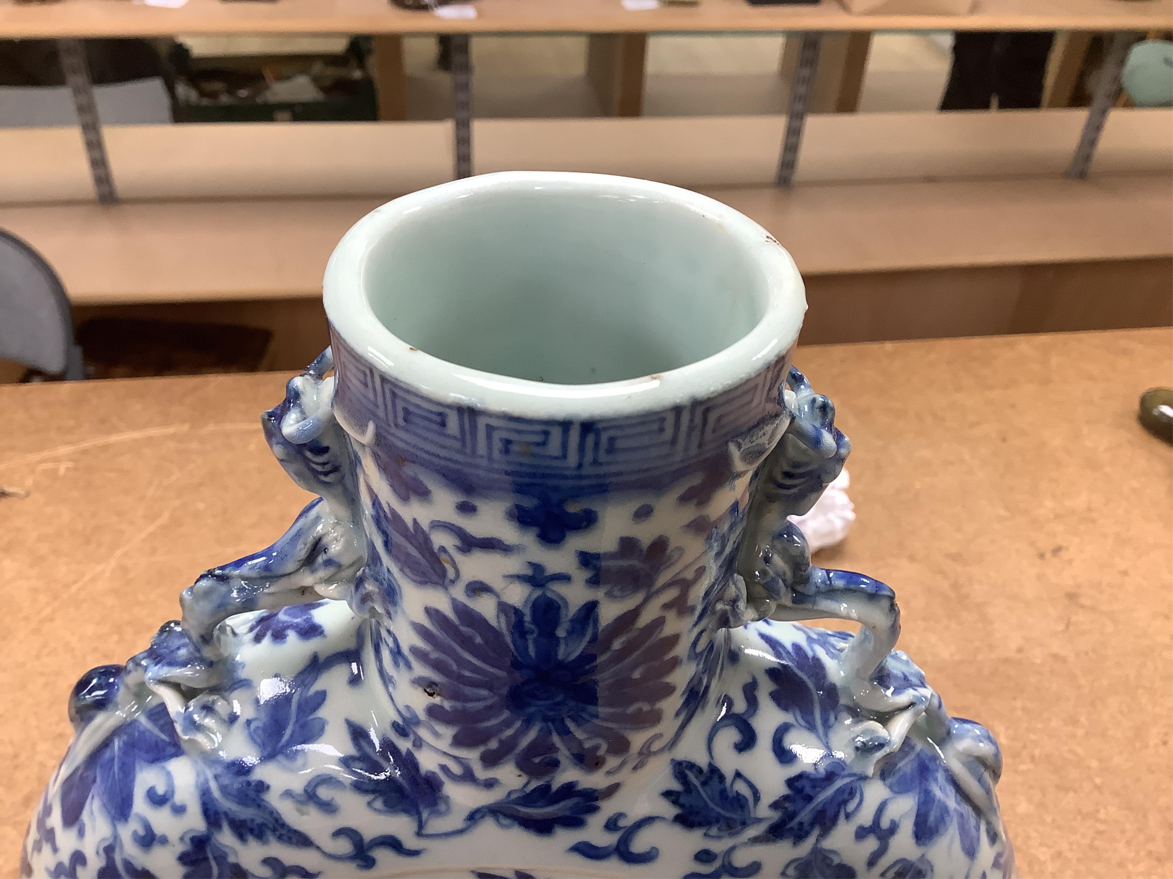 A 19th century Chinese blue and white moon flask on a hardwood stand, overall 35cm high. Condition - typical minor glaze imperfections